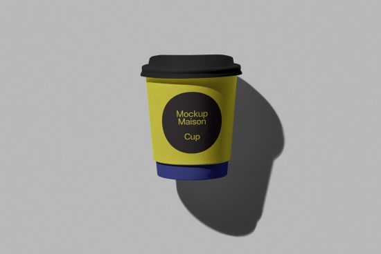 Yellow coffee cup mockup with black lid and blue holder, editable branding design, realistic shadows, isolated on grey, ideal for designers.