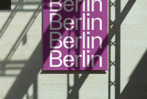 Purple poster with repeated 'Berlin' text in bold, modern font, shadow play on wall, ideal for graphic designers seeking typography inspiration.