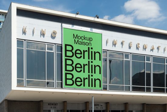 Urban billboard mockup on cinema building displaying bold text 'Berlin' for graphic design and advertising presentation.