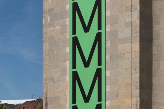 Green banner with bold black 'M' lettering on building facade, clear sky backdrop, modern design graphic poster, urban typography art.