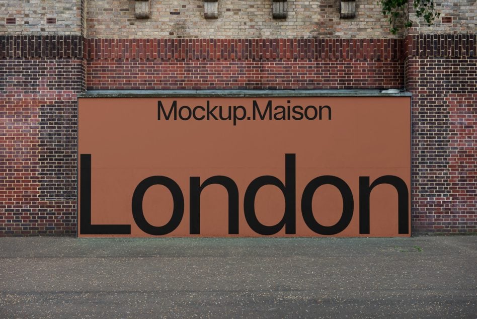 Wide orange storefront hoarding on brick wall with bold text