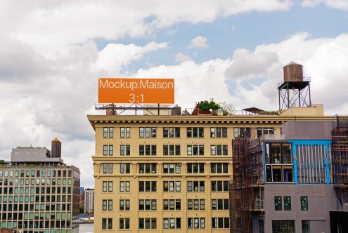 Urban billboard mockup on building rooftop with clear sky, ideal for designers to showcase advertising designs in a realistic environment.