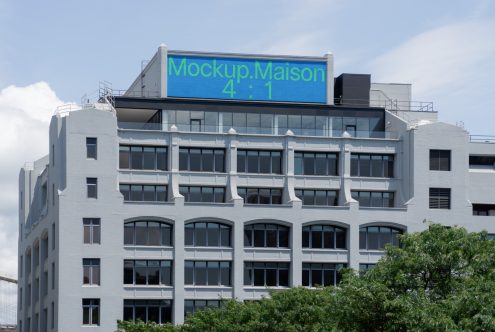 Urban billboard mockup on building top under clear sky for outdoor advertising graphic design presentations.