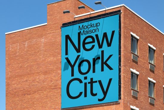 Urban billboard mockup featuring bold typography with text "New York City" on building facade, clear blue sky background, editable design.