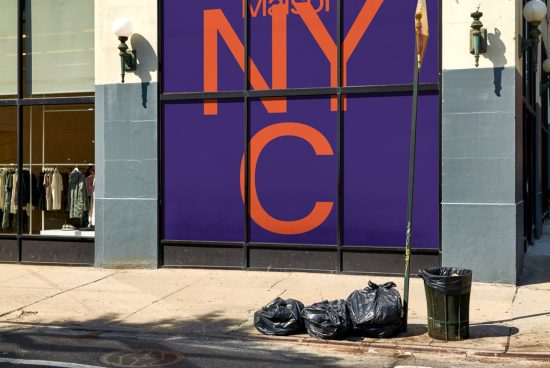 Urban store facade with large typographic window display design in purple and orange, featuring city acronym, street scene for mockups.