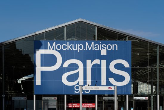 Modern billboard mockup displayed on a building facade with clear blue sky for advertising design templates in a metropolitan setting.