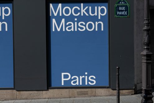 Street-level advertisement mockup with bold typography reading Mockup Maison Paris on a blue background, showcasing urban branding.