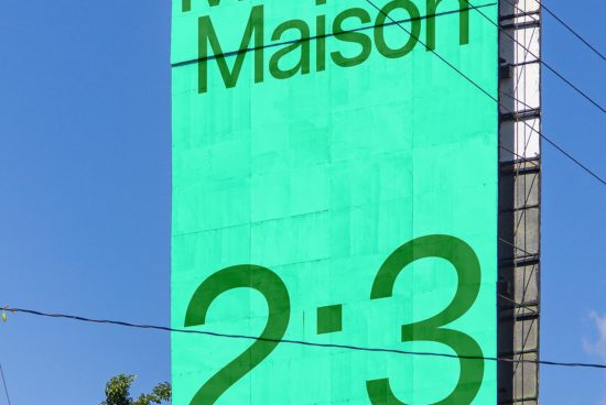 Green billboard with bold typography design, possibly a mockup for advertising, clear blue sky in background, with visible power lines.