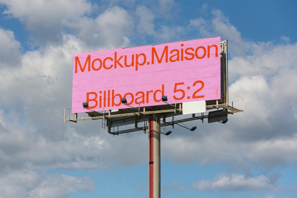 Light pink billboard with orange text on a cloudy day