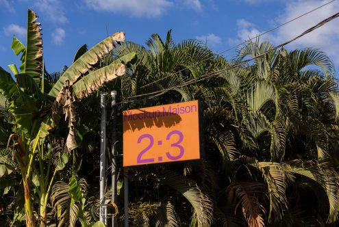 Outdoor sign mockup with tropical foliage background suitable for design presentations, advertising, and graphic templates.