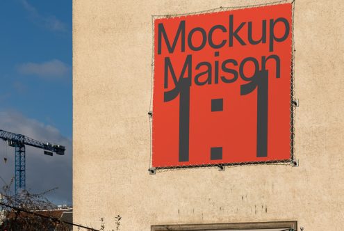 Bold red mockup sign on building exterior, clear sky, design presentation concept, graphic display template for designers.