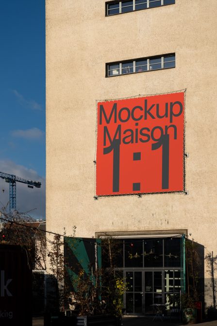 Red banner on beige building facade with black text reading Mockup Maison 1 1