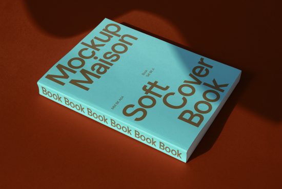 Mockup of light blue soft cover book on a textured brown background, ideal for graphic novel or script presentations.
