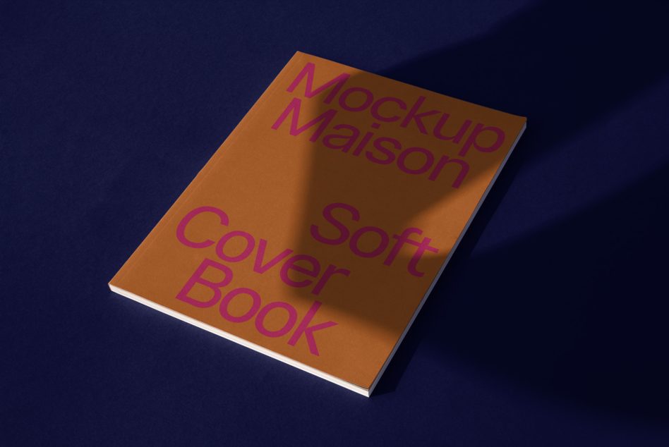 Gold softcover book on navy background with magenta typography