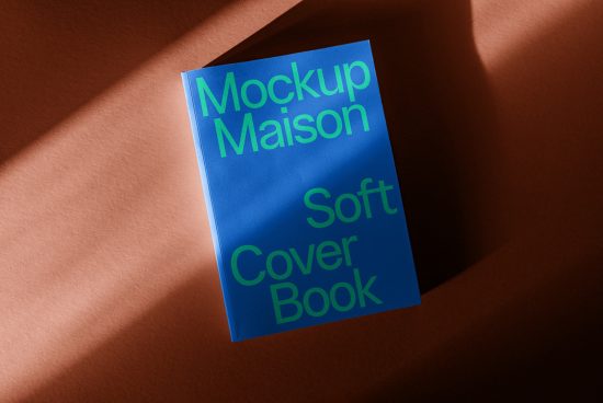 Blue soft cover book mockup with modern typography on terracotta background for designers, realistic presentation, editable template.