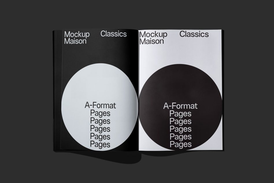 Open black book spread with white left page, black right page showing large circles