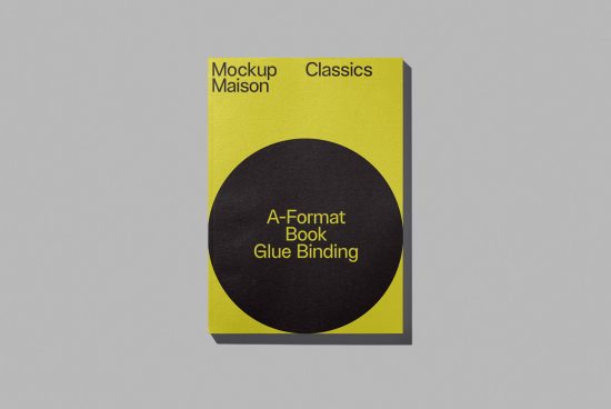 Yellow book cover mockup with black circle design on grey background showcasing A-format glue binding for digital asset marketplace.