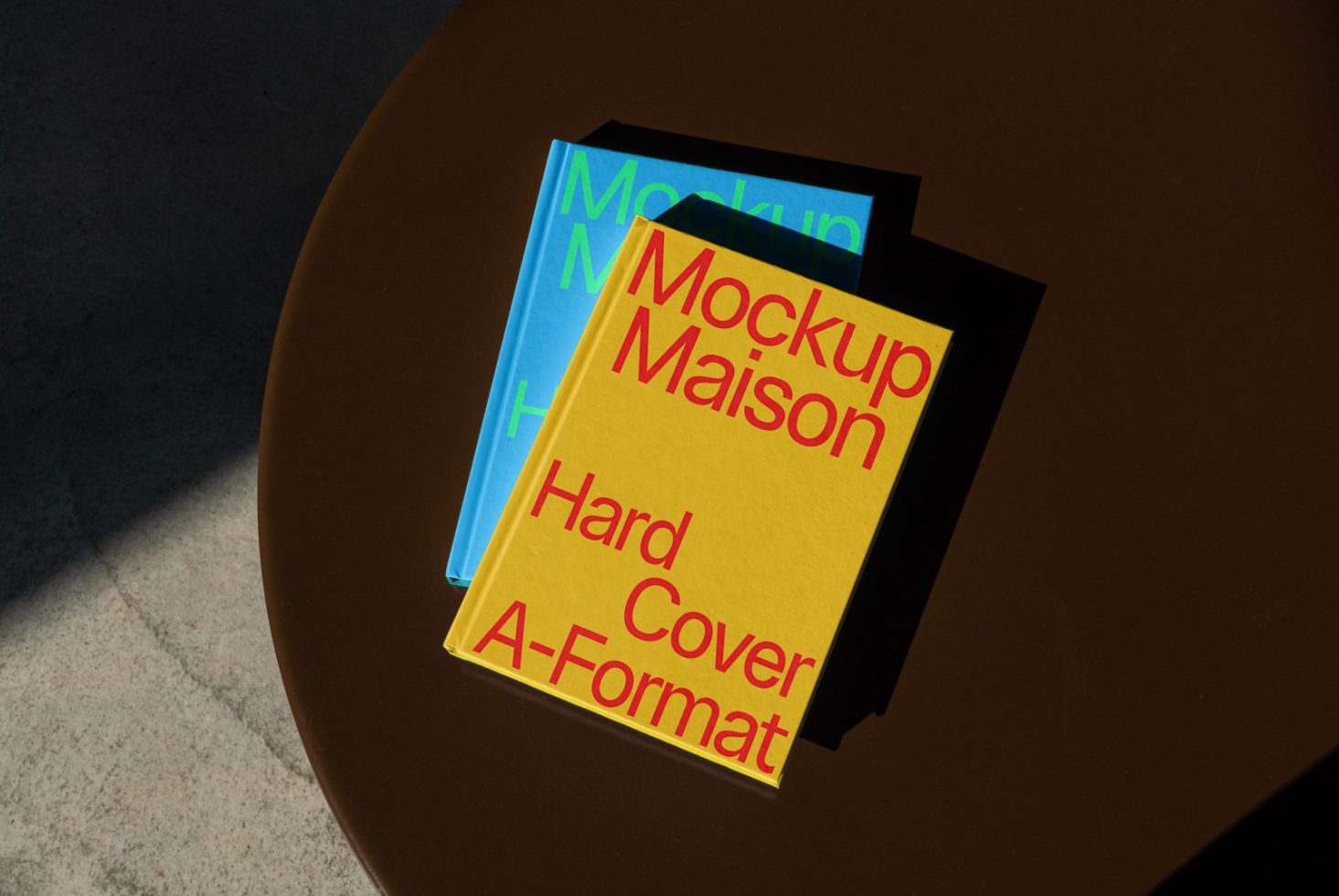 Book mockups on brown table with sunlight shadow, showcasing hardcover design for presentation, ideal for designers' portfolio assets.