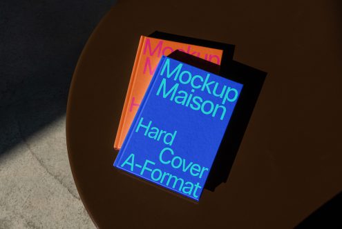 Hardcover book mockups on table with shadows, design presentation tool, creative digital asset for designers, realistic photorealistic mockup.