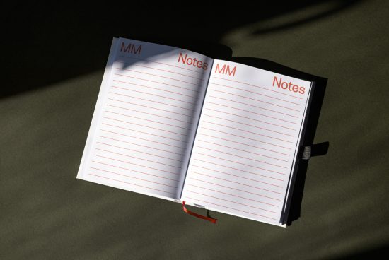 Open notepad with red lines on dark background creating a striking mockup for presentations or showcasing notebook design.