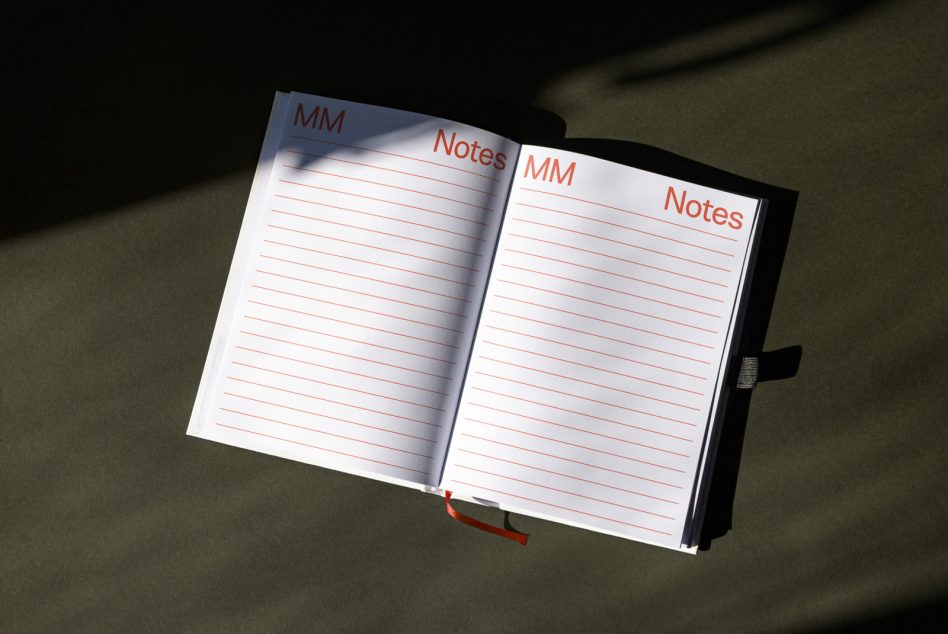Open notebook with red text lines, MM Notes header on white pages