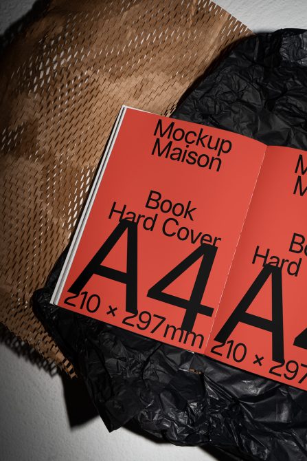 A4 hardcover book mockup on textured background showcasing cover design, ideal for designers to present artwork, graphics.