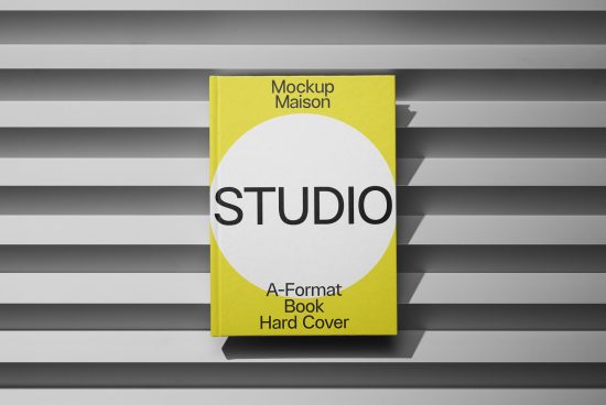 Yellow hardcover book mockup on striped gray background for graphic designers, showcasing cover design and layout presentation.
