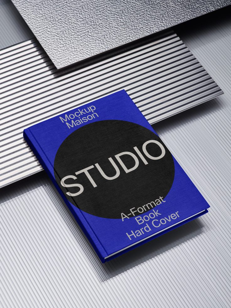 Blue hardcover book mockup on striped texture for design presentation, titled STUDIO in Mockup Maison, A-Format Book, suitable for graphic designers.