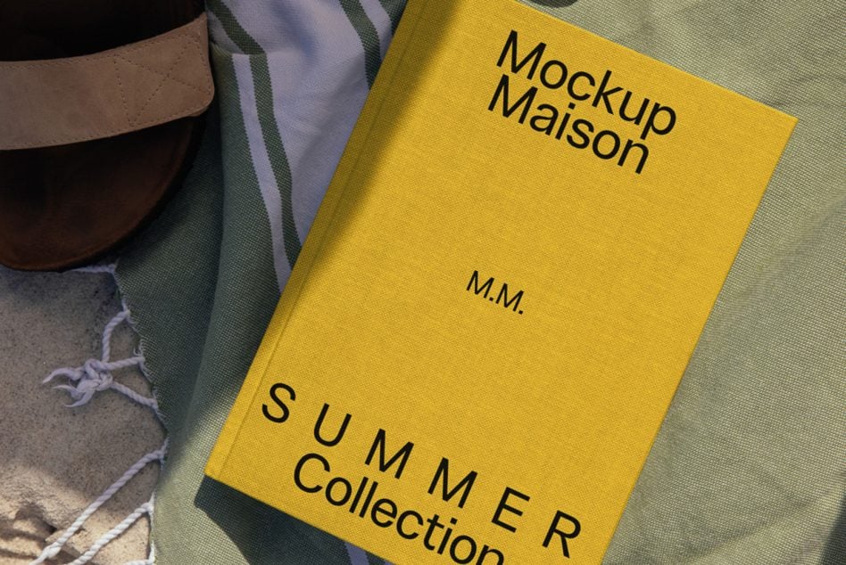 Golden yellow book mockup on beach towel with neutral tones