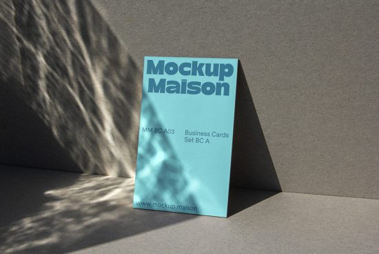 Professional business card mockup design with shadows, standing on a textured surface in natural light, ideal for showcasing branding projects.