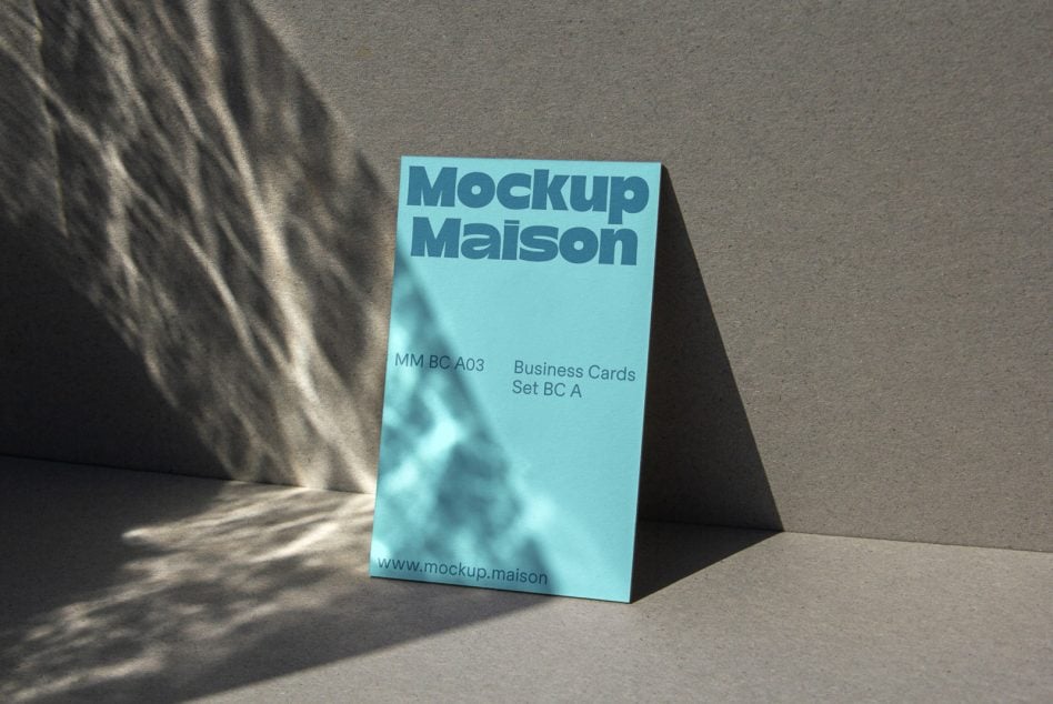 Light blue business card box standing upright on gray concrete