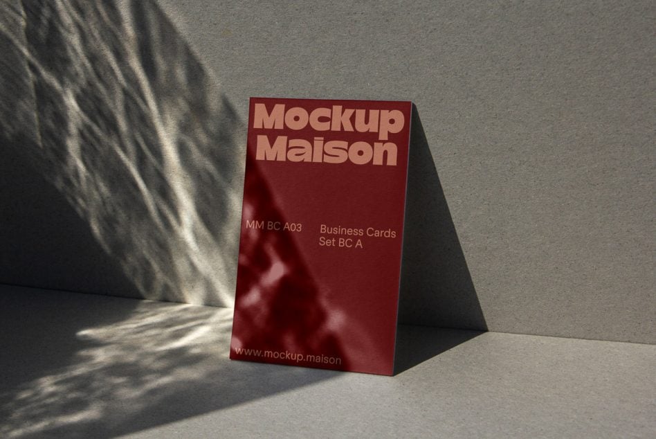 Deep red business card box mockup standing on concrete surface
