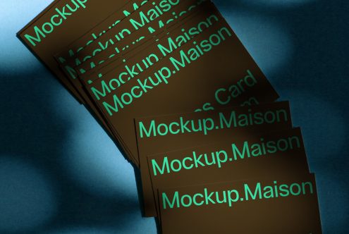 Stack of business cards with reflective typography mockup on blue background for graphic designers, editable PSD template.