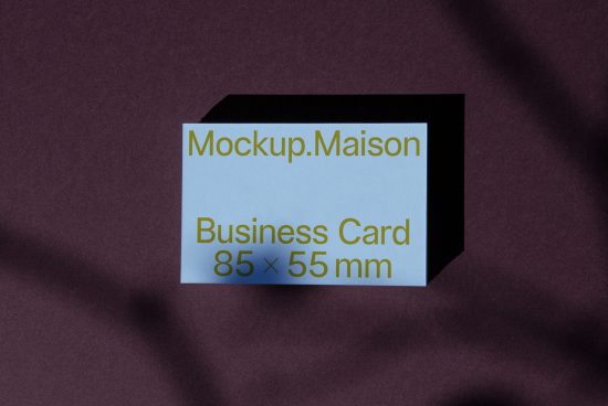 Elegant business card mockup on purple fabric, showcasing design space dimensions, ideal for presentations and portfolio display.