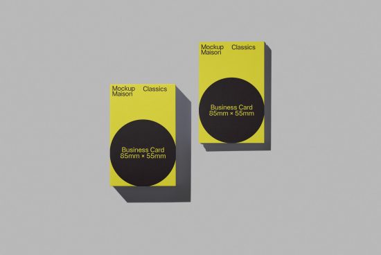 Yellow business card mockup with black circle design element against a gray background, showcasing front and stacked side views for graphic designers.