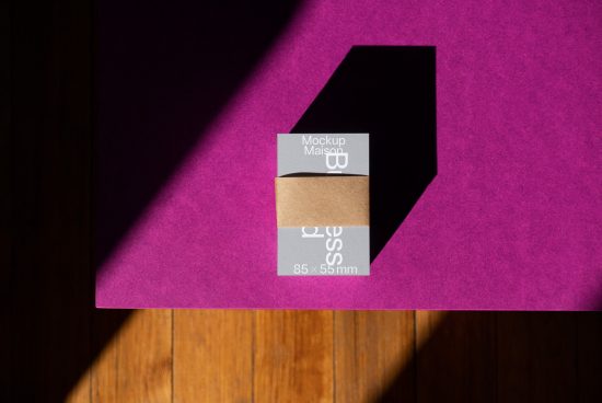 Business card mockup on purple surface with contrasting shadows for realistic branding presentation, ideal for graphic designers.