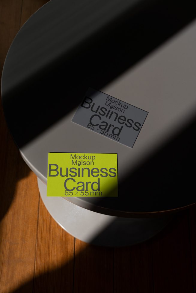 Elegant business card mockups with natural shadows on wooden surface, ideal for realistic branding design presentations.