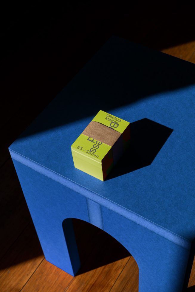 Mockup of business cards stack on blue stool with deep shadows, ideal for realistic branding presentations, graphic design assets.