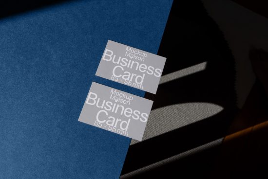 Business card mockup with shadow overlay on blue textured surface, demonstrating realistic design presentation for digital asset marketplace.