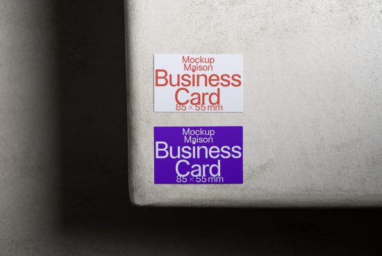 Two business card mockups on concrete with shadows, showing front design layout for graphic designers, 85x55mm.