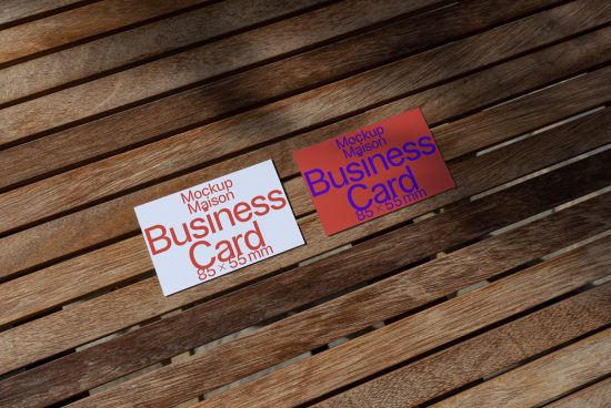 Business card mockups on wooden slats displaying graphic design and print layout, useful template for branding presentations by designers.