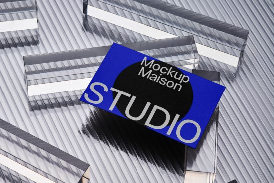 Business card mockup with blue card on a reflective geometric background, showcasing design space for logos and branding for designers.
