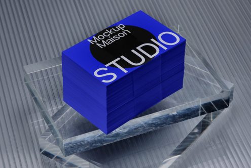 3D logo mockup on textured business cards stacked on a clear crystal podium with a metallic background for designers.