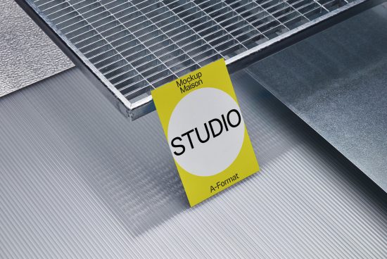 Flyer mockup on metal surface, with yellow design, for graphic designers, showcasing studio branding, A-format, realistic textures, print ready.