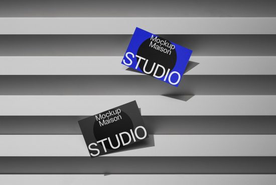 Business card mockup with dynamic shadows on a geometric striped background, showcasing design versatility for logo and brand presentation.
