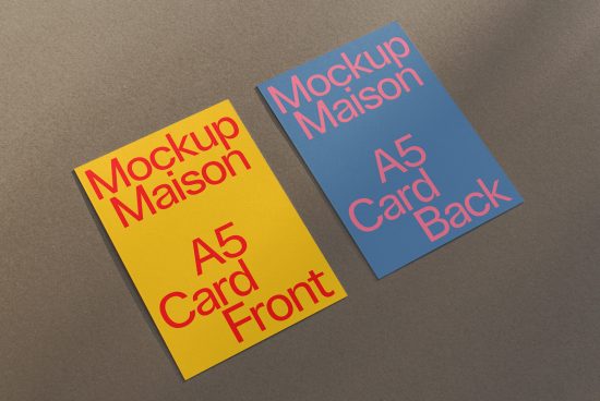 A5 size card mockups in yellow and blue lying on a brown surface, ideal for graphic design presentations and portfolio display.