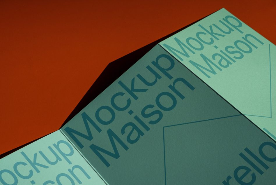 Mint green folded brochure mockup with teal text on rust orange background