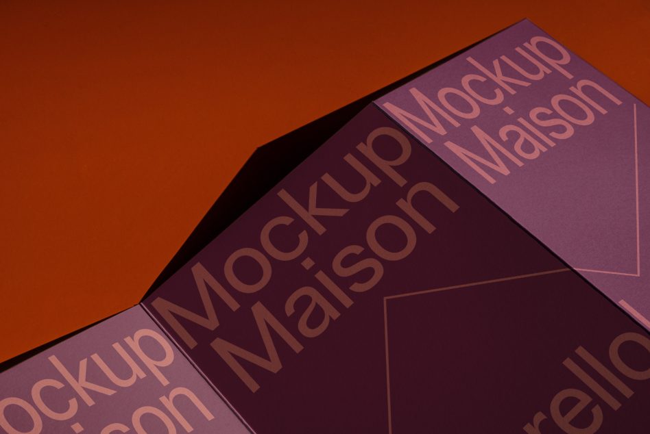 Opened tri fold brochure in deep burgundy with copper text on warm orange backdrop