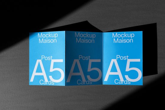 Blue A5 card mockups on dark background, dynamic shadows, showcasing print design, for designers and creatives, printable cards template.