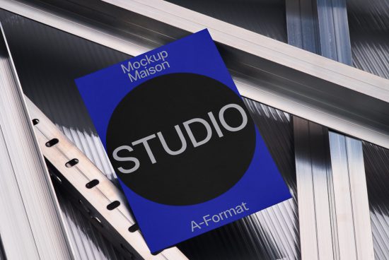 Modern magazine mockup with blue cover featuring the word STUDIO on metal binding, ideal for design presentations, graphic display.